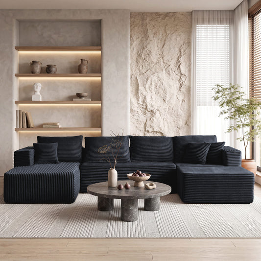 [Black] corduroy U-shaped sectional sofa — full front view in modern minimalist living room with stone round coffee table and built-in illuminated shelving, showing 4-seat plus dual chaise layout